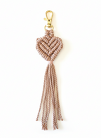 Macrame heart keychain with tassels on a white background