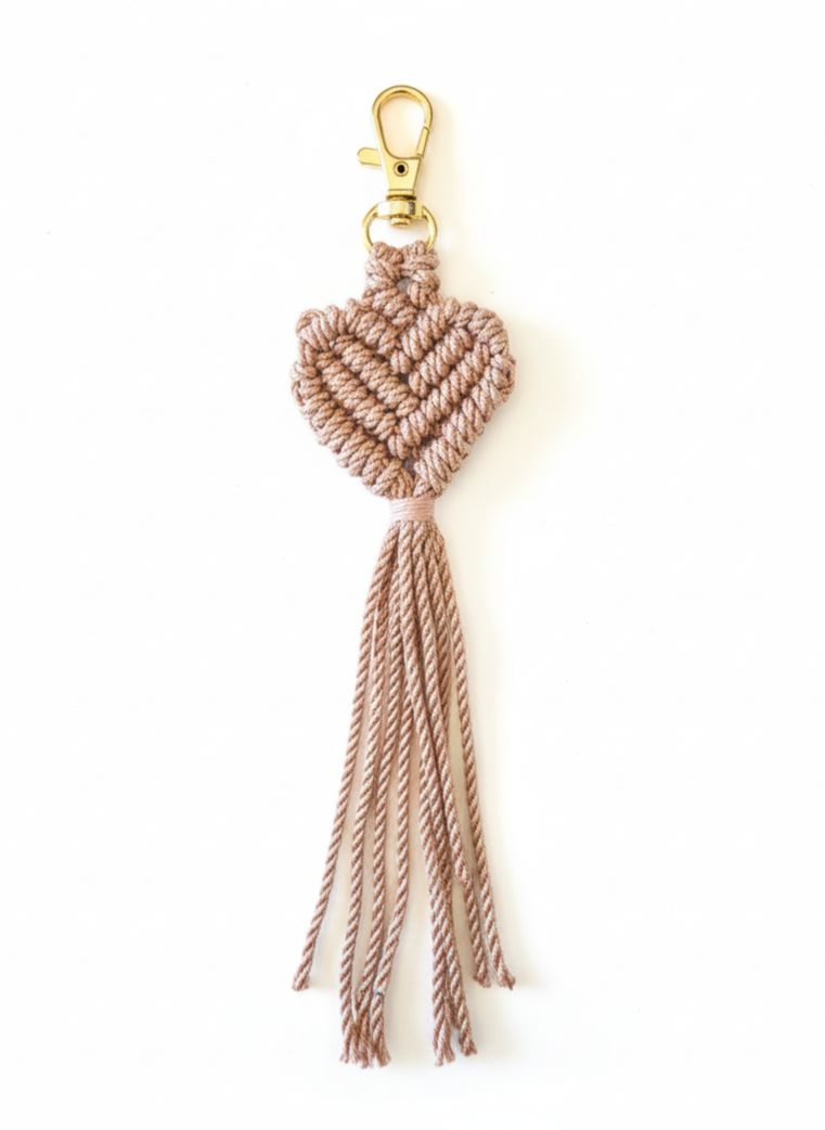 Macrame heart keychain with tassels on a white background