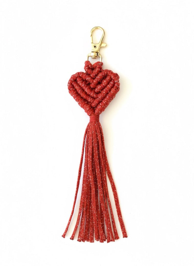 Red tassel keychain with a gold clasp on a white background